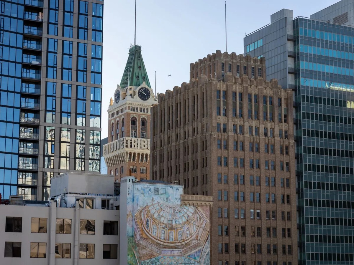 A dense collection of downtown sky-rises including a clock tower at the center.
