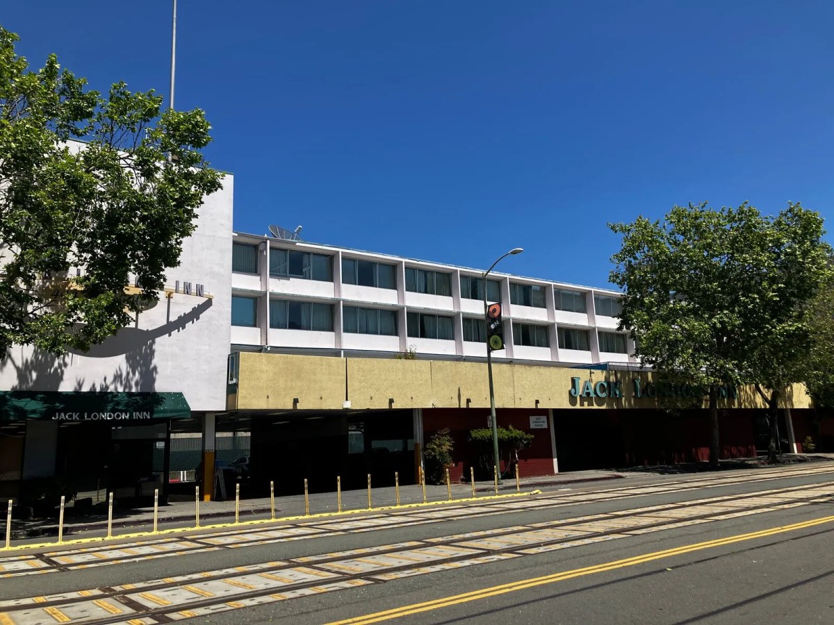 Long two- or three-story motel building with a parking garage.