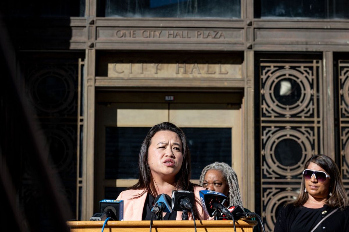 Sheng Thao, looking concerned, speaks at a podium outdoors.