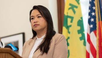 Oakland Mayor Sheng Thao stands at a podium.
